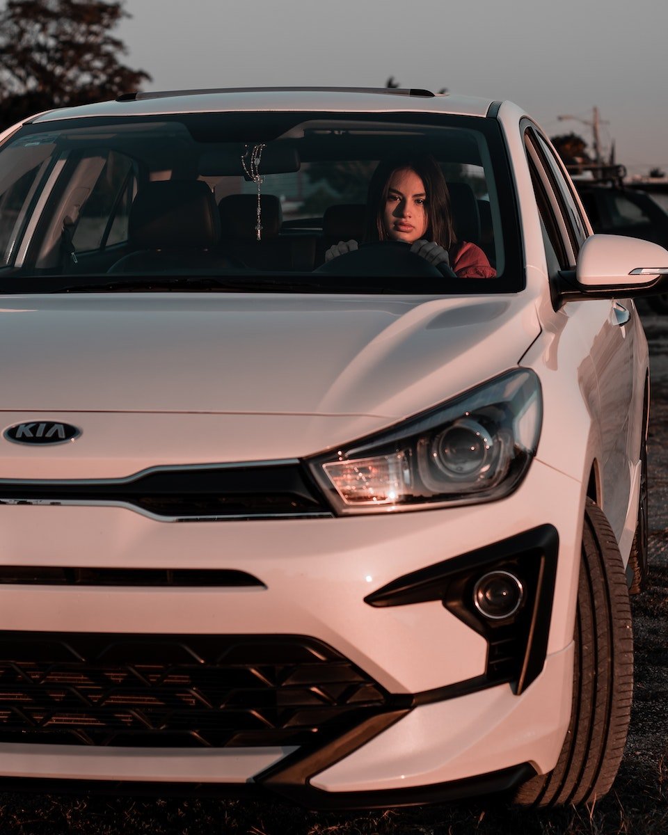 Photo of a Woman Driving a White Car