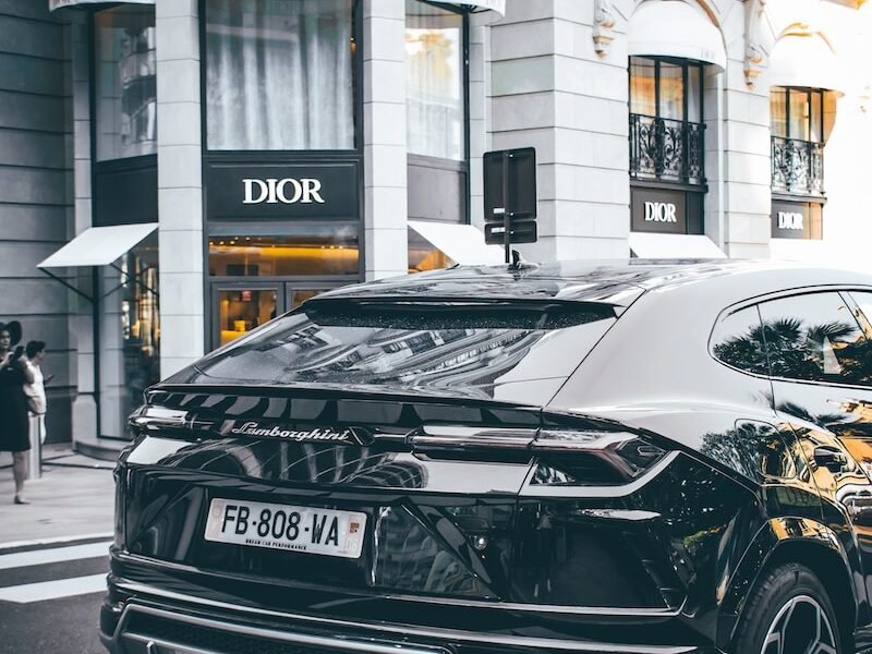 black car photo across Dior store