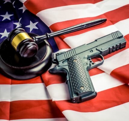 a gun, a judge's hammer, and an american flag