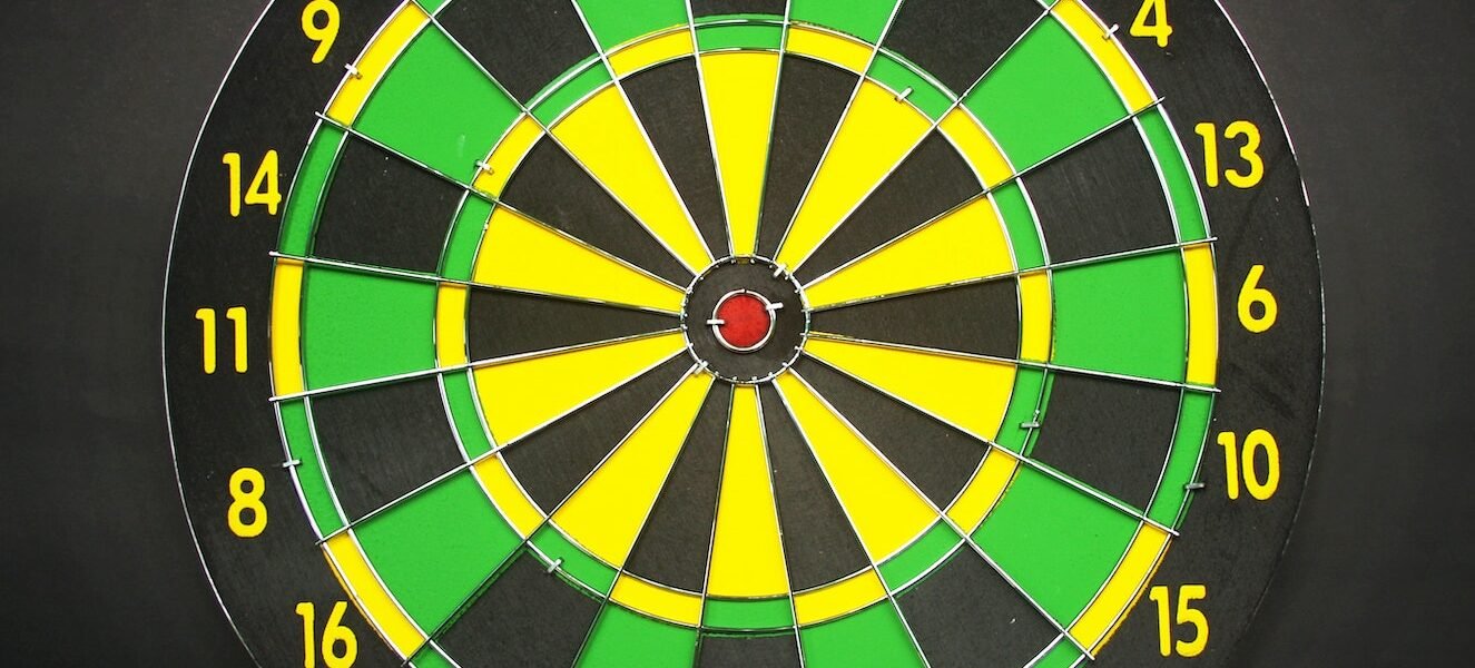 Green Yellow and Black Round Dart Board With Black Background