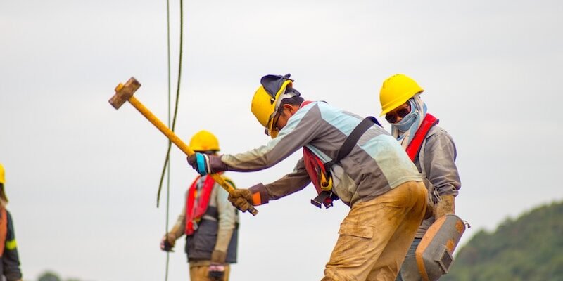 construction worker men holding hammer
