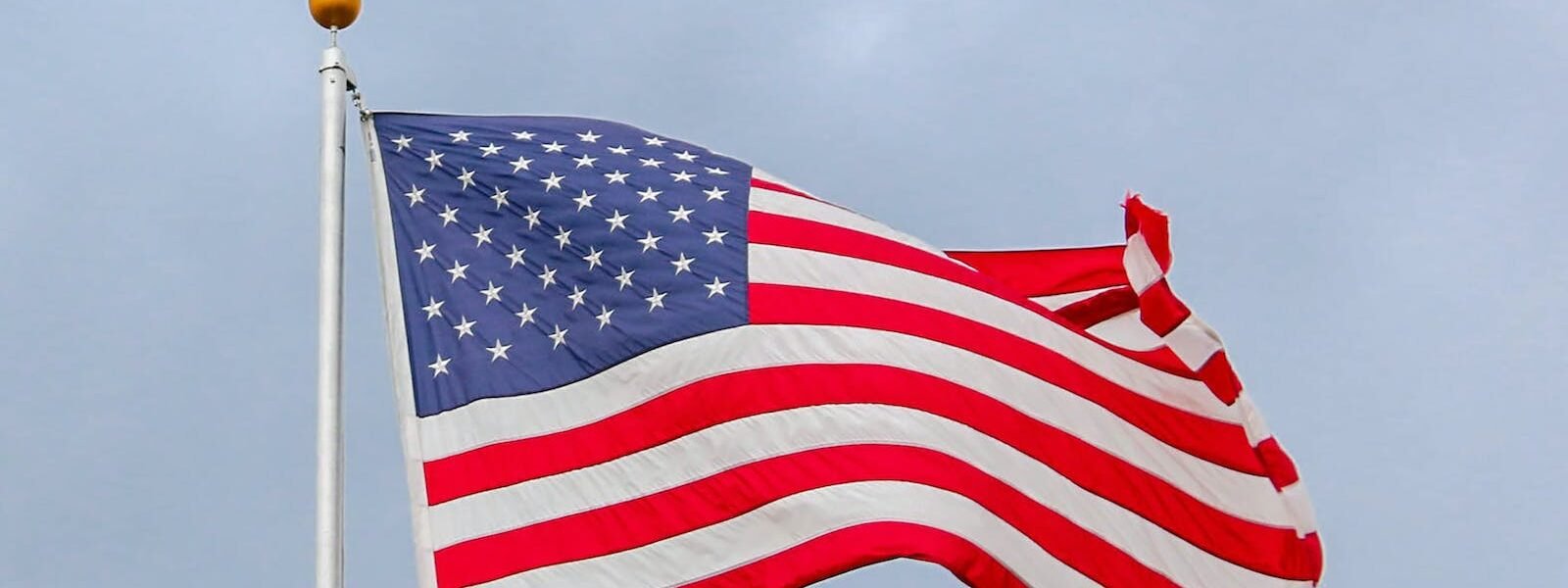 Usa Flag Waving On White Metal Pole